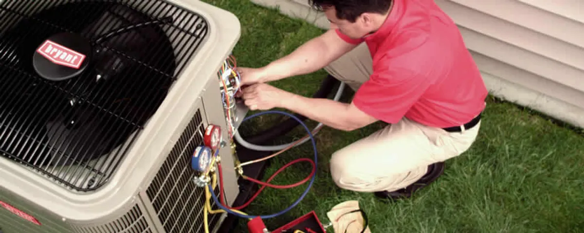 HVAC technician servicing an outdoor air conditioner unit in Greensboro, NC